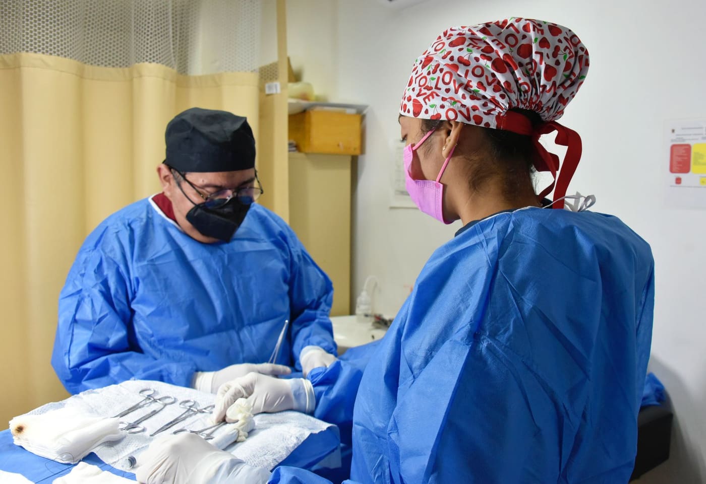 Clinical professionals preparing instruments for structural-heart procedures